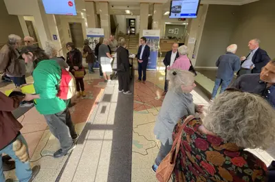 People in a foyer speaking in groups