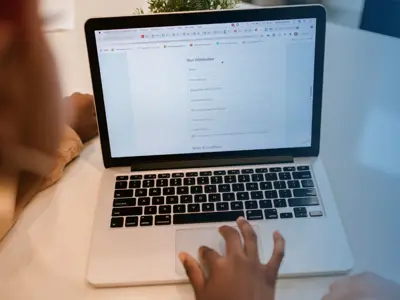 A person is filling out a form on a computer