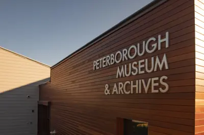 Exterior of Peterborough Museum with the facility name on the wall