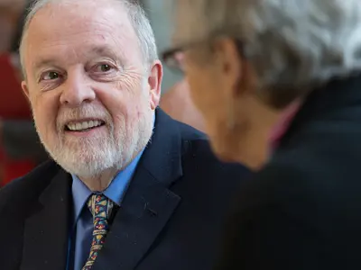 Two older adults speaking to each other