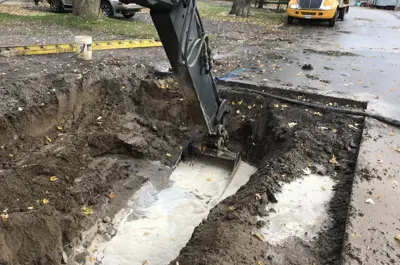Backhoe digging underground water line