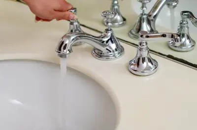 Hand turning tap for bathroom sink